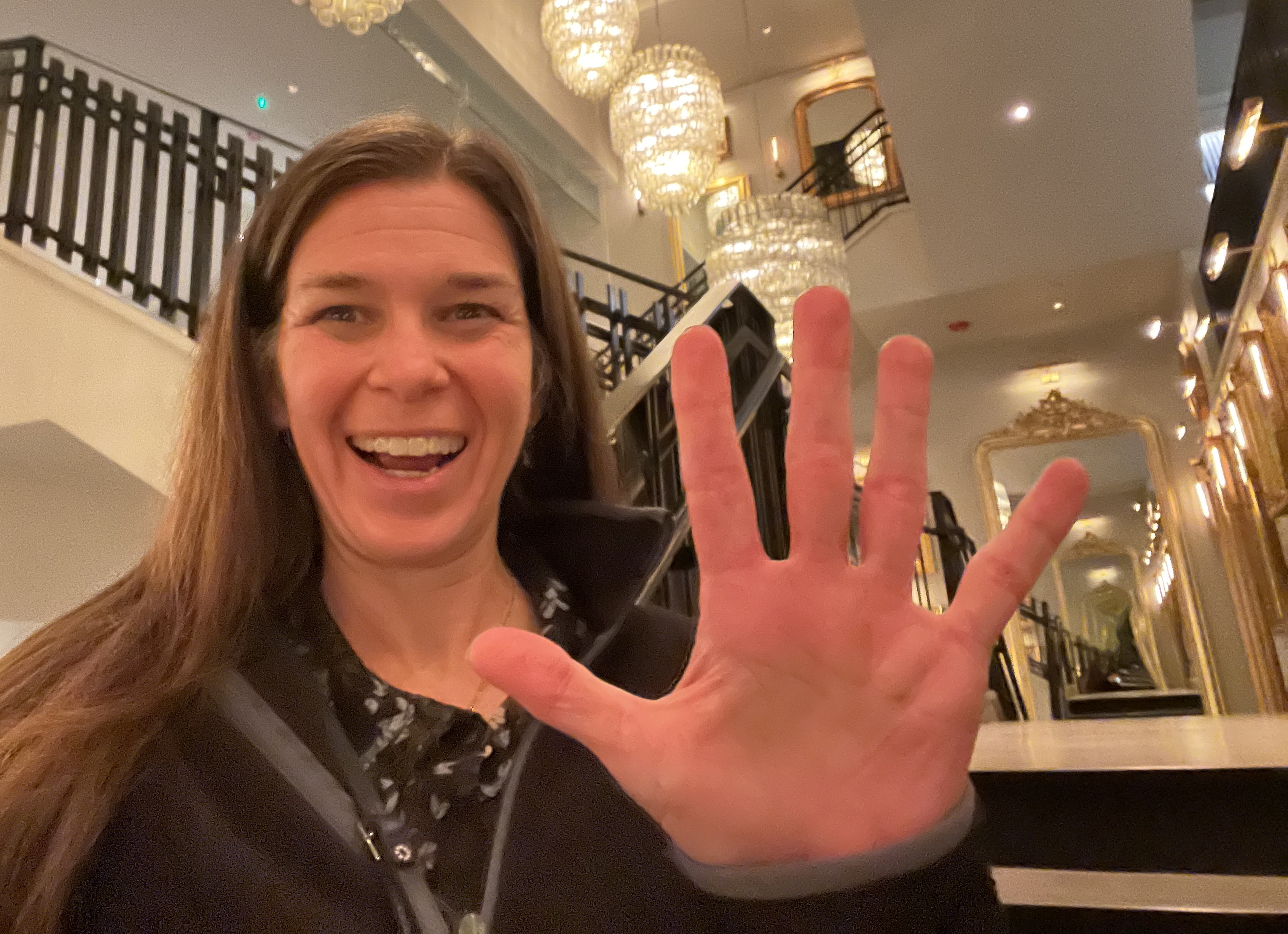Alexis Rago holds up 5 to celebrate Marketing Mana's 5th Business Anniversary